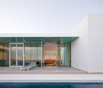 Deep glass soffits cast watery reflections overhead.