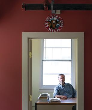 Wilson in his small, modest office; there he keeps a grainy black-and-white photograph of his 300-year-old Pennsylvania boyhood home, where he said he learned to appreciate nature. 