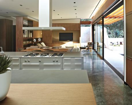 Work, dining, and seating-counter areas, oriented toward the screen, also enjoy views of the adjacent pool deck.

