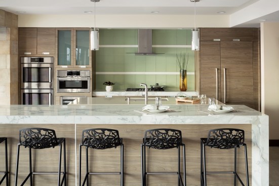 Hot Spot The kitchen is the undisputed focal point of the main living space, as a location for entertaining, relaxing, or serious cooking. It is equipped with two islands, state-of-the-art appliances and vent hood from Bosch, a Kohler faucet and sink, and countertops made of DuPont Zodiaq quartz and Walker Zanger Calacata Carrara marble.