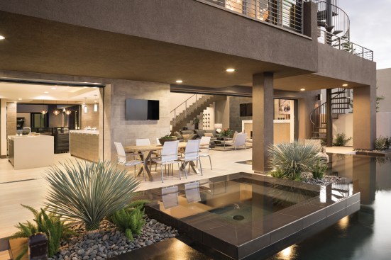 Desert Oasis The line between indoors and out is blurred by several clever design tricks. Sierra Pacific sliding pocket doors recede into the walls to create doorways up to 26 feet wide, and Walker Zanger flooring extends from interior rooms to the courtyard, up to the edge of the pool. “The materials we’ve used tie the spaces together,” Miquel Hutton says. “The idea  is to draw people out to those areas using those materials to make it look seamless.”