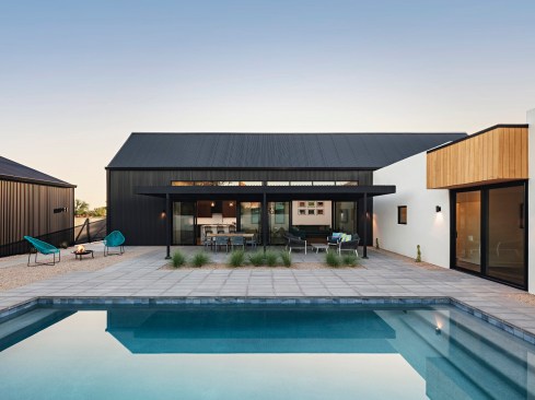 Two volumes, the main home and detached garage, create a three-sided courtyard with room to gather and relax around the pool or fire.