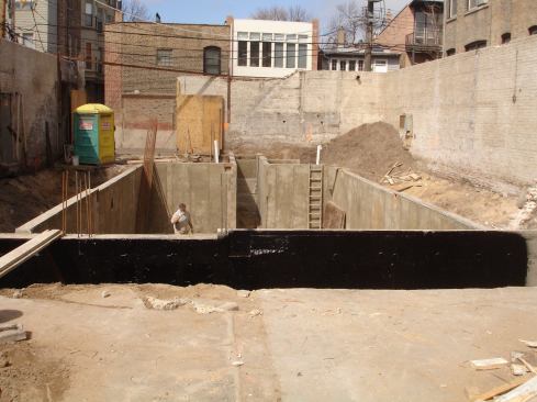 With the four sided, 10-foot tall braced masonry box that remained, a 40 by 20 by 10-foot deep basement was excavated. 