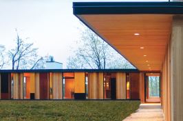 In an effect inspired by the forest that surrounds it, views through this new lakeside home shift with one’s perspective. Its unfinished red cedar siding will gray to blend with the tree trunks.
