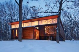 A cubelike mid-level entry makes a virtue of the feature that once distinguished this house as a "raised ranch".