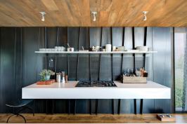 Folded blackened steel panels help express the new
structural system. The panels—solid or mesh, depending on the application—are used in various locations
throughout the home from wall panels to lighting details to stair risers.