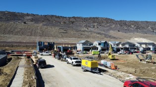 A drilling rig drills boreholes for the Dandelion Energy geothermal ground-source heat pumps being installed in newly built homes from Lennar in the Ken Caryl neighborhood of Littleton, Colorado.